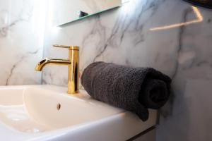 a bathroom sink with a towel next to a faucet at Selene Houseboat Polańczyk in Polańczyk +21 photos