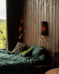a bedroom with a bed with two lamps on it at Silence cabin in Myta