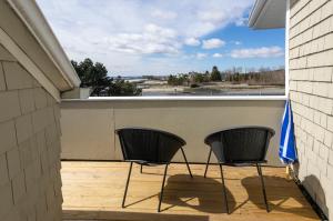 two chairs sitting on the porch of a house at Breakwater Inn in Kennebunkport +30 photos