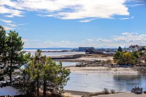 a view of a river with trees and buildings at Breakwater Inn in Kennebunkport