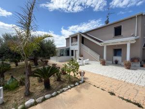 a large white house with a patio and trees at VILLA NATURA in Corropoli