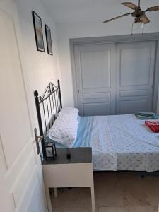 a bedroom with a bed and a ceiling fan at B10 Las Arenas in Caleta De Fuste