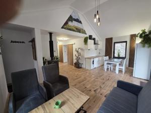 a living room with a couch and a table at Nestor Baron in Borkowo
