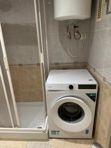 a washer and dryer in a small bathroom at Promar Playa 255 in La Pineda