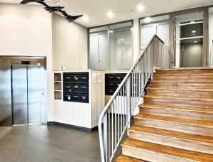 a staircase in a kitchen with a stair case at Appartement T2 vue panoramique sur Annecy in Seynod