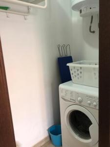 a laundry room with a washing machine in a room at Sunset Casita in Alora