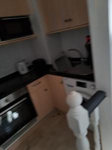 a small kitchen with a stove and a sink at B10 Las Arenas in Caleta De Fuste +5 photos