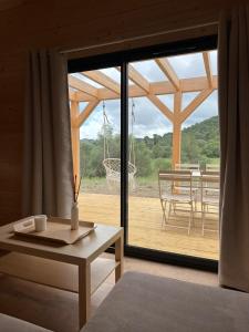 a living room with a large sliding glass door at Chalet de Saint Martin in Roquefort-des-Corbières