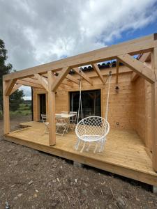 a house with a porch with a swing at Chalet de Saint Martin in Roquefort-des-Corbières