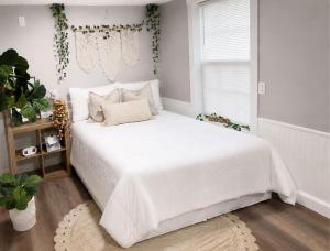 a white bed in a room with a window at Tropical Casita LaVida in Tampa +47 photos
