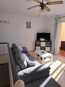 a living room with a couch and a table at B10 Las Arenas in Caleta De Fuste