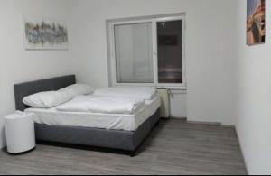 a small bedroom with a bed and a window at Mozart Salzburg Residence in Salzburg