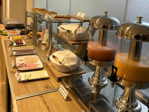 a counter with a buffet of food and a mixer at Hotel Inclan in Lima