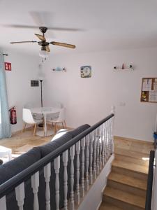 a staircase in a living room with a table at B10 Las Arenas in Caleta De Fuste
