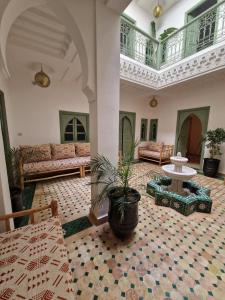 a living room with a couch and a table at Riad Dar Yamna Marrakech in Marrakesh