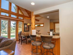 a kitchen and living room with a table and chairs at Running Y Resort in Klamath Falls