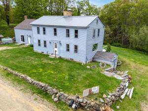 an aerial view of a white house with a yard at Highland Catttle Farm - Cozy Suite for Two - C in Loudon +6 photos