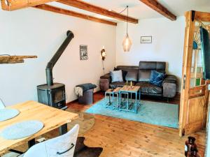 a living room with a couch and a wood stove at Ferienwohnung Lütt Quickborn in Quickborn +10 photos