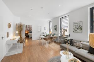 a living room with a couch and a table at Stay COZY - The Lounge- Kingsize - Terrasse - Beste Lage in Aschaffenburg