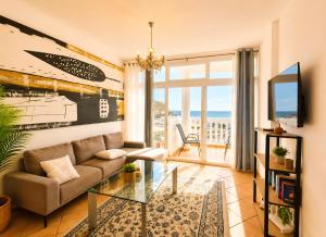 a living room with a couch and a glass table at Lina Mogan in Puerto de Mogán