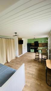 a room with a bed and a table and chairs at Studio Saint Julien de Concelles 5 minutes de la Loire in Saint-Julien-de-Concelles
