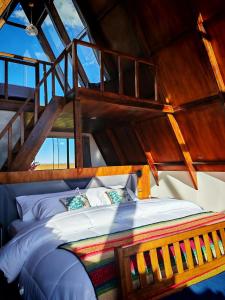 a large bed in a room with wooden ceilings at Titicaca Star Perú in Puno