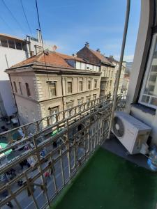 a balcony with a washing machine next to a building at FG Apartment in Sarajevo