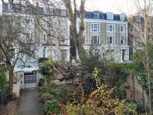 a house with a gate in front of it at Luxury Holland Park, sleeps 2, Free S'fast WiFi in London