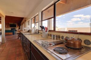 a kitchen with a stove with a tea kettle on it at Golf, Lakes & Trails! Truth Or Consequences Home in Truth or Consequences