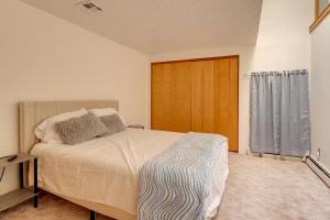 a bedroom with a bed and a wooden door at Golf, Lakes & Trails! Truth Or Consequences Home in Truth or Consequences +23 photos