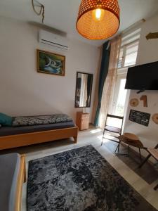 a bedroom with a bed and a table and a lamp at FG Apartment in Sarajevo