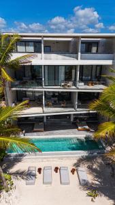 an aerial view of a building with a swimming pool at Luxury Beachfront 3BR Appartment in Tulum