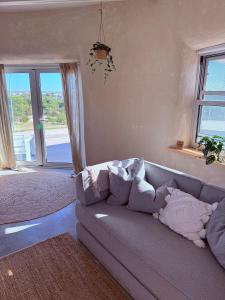 a living room with a couch with pillows on it at Whales and Bales in Bremer Bay