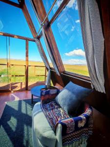 a bed in a room with a large window at Titicaca Star Perú in Puno +17 photos