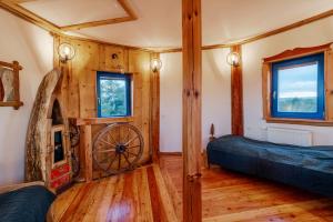 a room with a fireplace in a wooden house at Tylko Dobro Siedlisko na Jurze in Pabianice
