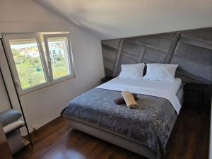 a bedroom with a bed with a towel on it at Apartmani Novia in Bibinje +55 photos