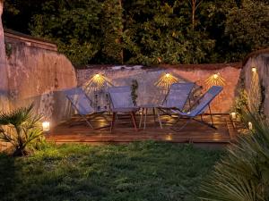 a table and chairs on a deck at night at L'Echoppe en ville in Amboise