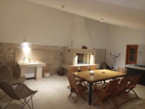 a kitchen with a table and chairs and a fireplace at Villa Ivana in Medulin