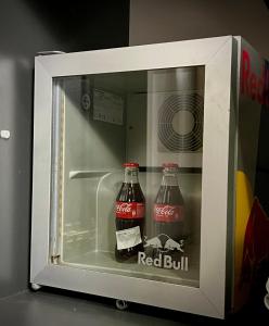 two bottles of coke in an open refrigerator at Guesthouse Yildiz in Sarajevo