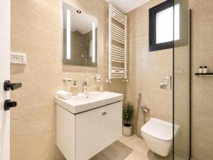 a bathroom with a white sink and a toilet at Prestige House La Marsa Terrasse Jacuzzi & Garage in La Marsa +11 photos