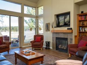 a living room with a tv and a fireplace at Running Y Resort in Klamath Falls
