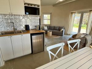 a kitchen and living room with a sink and a couch at Whales and Bales in Bremer Bay