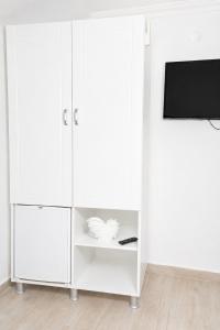 a white cabinet with a tv on top of it at Hayal Ada in Bozcaada