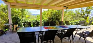 a patio with a table and chairs on a deck at ClaudiAgapi Apartments Korfu in Agios Stefanos +91 photos