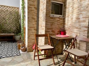 a patio with a table and chairs on a patio at Casa de Elena Marousi in Athens