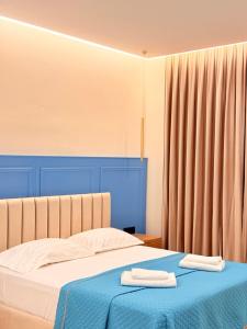 a bedroom with a bed with two towels on it at Rida Village Hotel Ksamil Island in Ksamil +67 photos