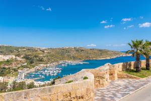 a view of a harbor with boats in the water at Harbour Views Gozitan Villa Shared Pool - Happy Rentals in Mġarr