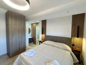 a bedroom with a bed with two towels on it at Villa Oronzo in Torre Lapillo