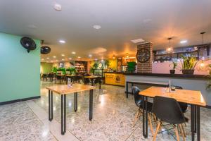 a restaurant with tables and chairs in a room at Mandala Medellín Centro By GyC Hotels in Medellín +17 photos