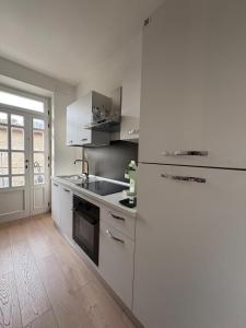 a kitchen with a white refrigerator and a stove at Vintage House in Asciano
